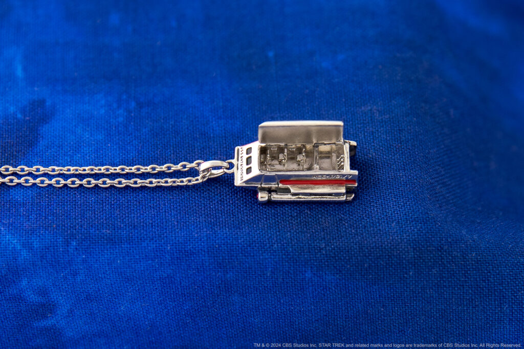 Galileo Shuttlecraft Pendant from Star Trek: The Original Series by Rocklove Jewelry shown with top open to reveal seats on the inside.