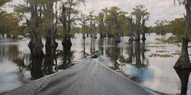 Eliza Scanlen as Ellie, driving a small boat on Caddo Lake