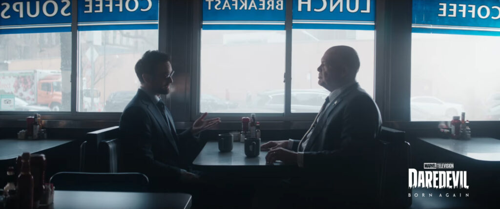 Matt Murdock and Wilson Fisk face sitting each other in a booth in an otherwise empty diner in NYC. Screenshot from the Disney+ Marvel 2025 "Look Ahead" trailer.