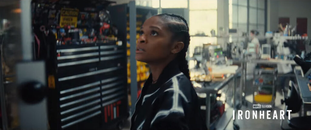 Riri Williams looks at plans on a whiteboard in a well-equipped lab space. Screenshot from the Disney+ Marvel 2025 "Look Ahead" trailer.