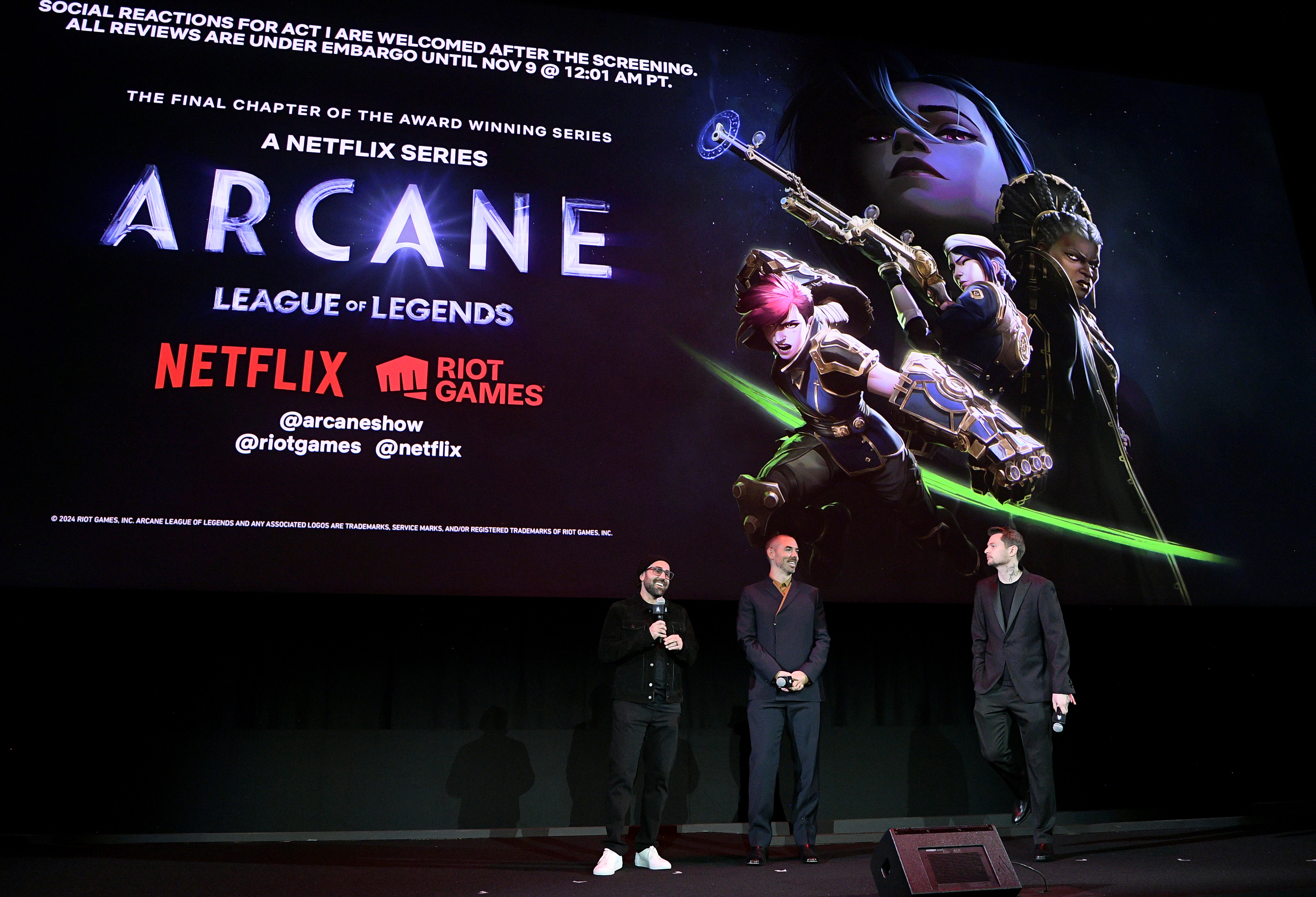 (L-R) On stage in front of audiences, Brandon Beck, Marc Merrill and Christian Linke speak onstage during the Netflix Arcane LA Premiere at The Egyptian Theatre Hollywood on October 30, 2024 in Los Angeles, California.  (Photo by Charley Gallay/Getty Images for Riot / Netflix)