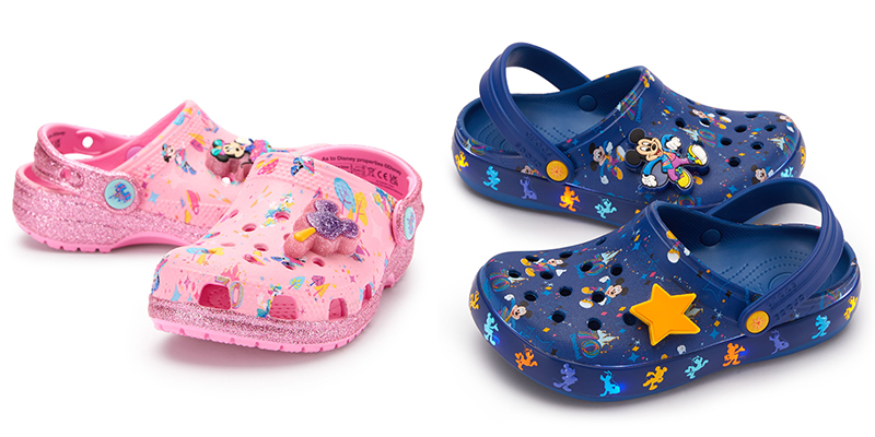 On the Left: Pink kid-sized Crocs with Minnie and Daisy in their anniversary outfits alongside stylized trees, teacups, and the castle printed on them. The back and bottom edge of the shoes are sparkly pink. One shoe has a Minnie shoe charm and the other has a pink and purple sparkly Mickey ice cream bar charm.
On the Right: Dark/royal blue kids' crocs with a print featuring Mickey Mouse and the 70th anniversary logo. One shoe has a shoe charm featuring Mickey. The other has a yellow star shoe charm. The bottom edge of the shoes feature silhouettes of Mickey and Pluto