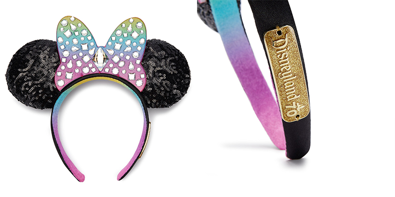 These Minnie Ears feature black sequin fabric for the ears and a large solid bow in an ombre rainbow with silver jewels in a variety of shapes and sizes on the bow- with one large diamond shaped jewel in the middle. The headband itself is black on top with an ombre rainbow fabric underneath. On the side of the headband is a gold rectangular plate that says "Disneyland 70"