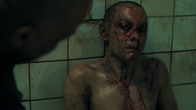 A tortured Seraphite looks up at Isaac. Blood, gashes and bruises cover his body.
