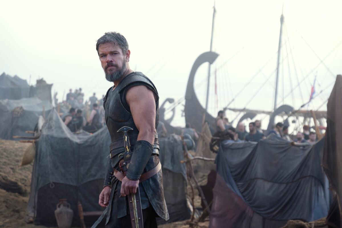 Matt Damon as Odysseus stands on the Trojan beach